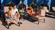 Family of 4 enjoying a poolside cabana