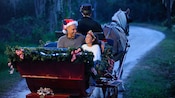Dad in Santa hat with daughter in princess outfit going for a sleigh ride