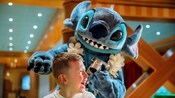 Stitch interactuando con un niño pequeño a bordo de un crucero de Disney