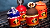 Four small The Incredibles themed cakes from Edna À La Mode Sweets