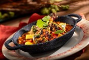 Pan served berbere spiced chicken from Pride Lands, Feast of the Lion King