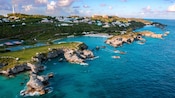 A coastal inlet beside a hill with a lighthouse in Bermuda A coastal inlet beside a hill with a lighthouse in Bermuda