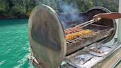 Meat skewers on a barbecue aboard a boat
