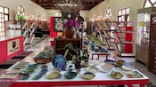 Interior of the Langkawi Craft Complex featuring handmade ceramics and pottery displayed on tables and shelves
