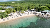 A beach cove with lounge chairs, cabanas and lush tropical forest of Falmouth, Jamaica
