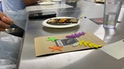 A chocolate bar on a plate next to custom decorated packaging