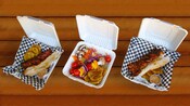 3 carryout boxes with grilled kebabs in San Juan, Puerto Rico