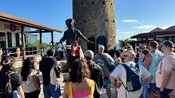 Guests gathered around a pirate statue near a historic watchtower at Blackbeard's Castle in Saint Thomas