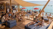 Guests relaxing on lounge chairs at Blu Ocean Club Cozumel in Cozumel