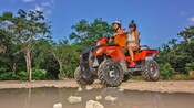 Two Guests riding an ATV off road