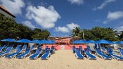 Loungers and umbrellas on the beach at Mollie’s Beach Club