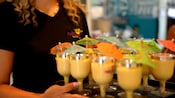 A server carrying a tray of frozen beverages