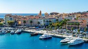 Various ships floating in the water near the city of Ajaccio, France