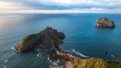 The islet of Gaztelugatxe, featuring a hermitage at its top and a winding walkway connecting it to the mainland