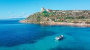 A Zodiac boat cruising the waters near the Calamosca tower in the Gulf of Cagliari