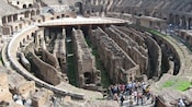 Un grupo de Visitantes contemplando la arena del Coliseo en Roma, Italia