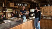 A shopkeeper barters with a woman in the general store at Vagsberget Museum in Maloy, Norway