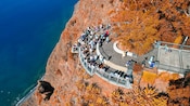 An aerial view of a group of people admiring the view from Cabo Girão skywalk