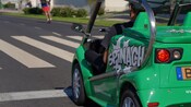 A Guest driving an electric tour vehicle along a street in Funchal, Portugal