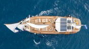 An aerial view of the Adonis luxury schooner on the water near Santorini, Greece