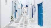 A charming narrow cobblestone alleyway in Mykonos, Greece