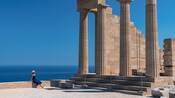 Ancient stone columns and ruins at Lindos Acropolis overlooking the Aegean Sea in Rhodes