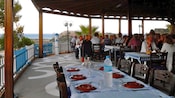 Guests having a meal in an outdoor seating area at the Taverna Mimakos in Rhodes, Greece