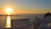 A balcony overlooking the sunset over the Aegean Sea in Santorini, Greece	
