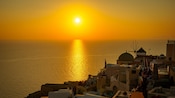 A sunset over the village of Oia on the island of Santorini, Greece