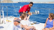 Guests seated in a boat are served beverages