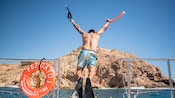 A Guest jumping off a catamaran into the ocean at Santa Maria Cove in Los Cabos, Mexico