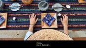 A Guest at a Mexican style table setting with painted pottery and woven textiles