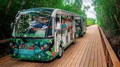 A Kuza Beach and Adventure Park tram carrying Guests through a jungle boardwalk trail