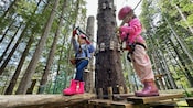 Two little girls setting up their gear to start the Adventure Park and Ropes Course in Icy Strait Point, Alaska
