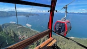 Gondolas traveling along a mountainside overlooking Icy Strait Point, Alaska