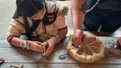 A guide showing a child how to make a drum by hand