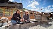Two Guests panning for gold at an outdoor sluice