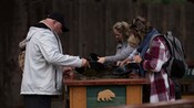 Guests panning for gold at a sluice table