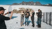 A tour guide taking a picture of 4 Guests holding puppies at Denver Glacier, Alaska
