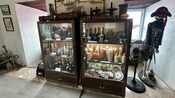 Two cabinets holding antique bottles and other vessels at Bluebeard’s Castle in Saint Thomas, US Virgin Islands