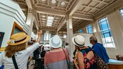Un guía llevando a Visitantes por un edificio bancario en Napier, Nueva Zelanda