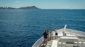 A family of Guests gathered on the bow of a whale watching ship as it sails through Mamala Bay off the coast of Oahu