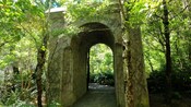 A stone archway in a forest, which served as the gate to Rivendell in The Lord of the Rings films