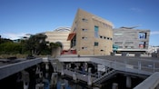 A modern waterfront museum with angular architecture, a boardwalk and a water feature