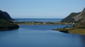 A small coastal community located on a narrow strip of land between 2 larger landmasses