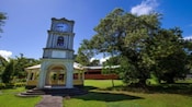 A clock tower and gazebo outside the Fiji Museum in Suva