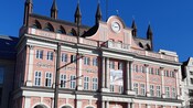 A decorative building with many windows and a small clocktower