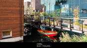 Several houses and a rowboat along a pier, with text below that says 'National Geographic Day Tours'