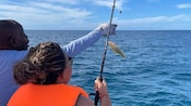A man and a woman fishing in the ocean