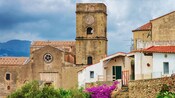Houses and an old stone church with a bell tower